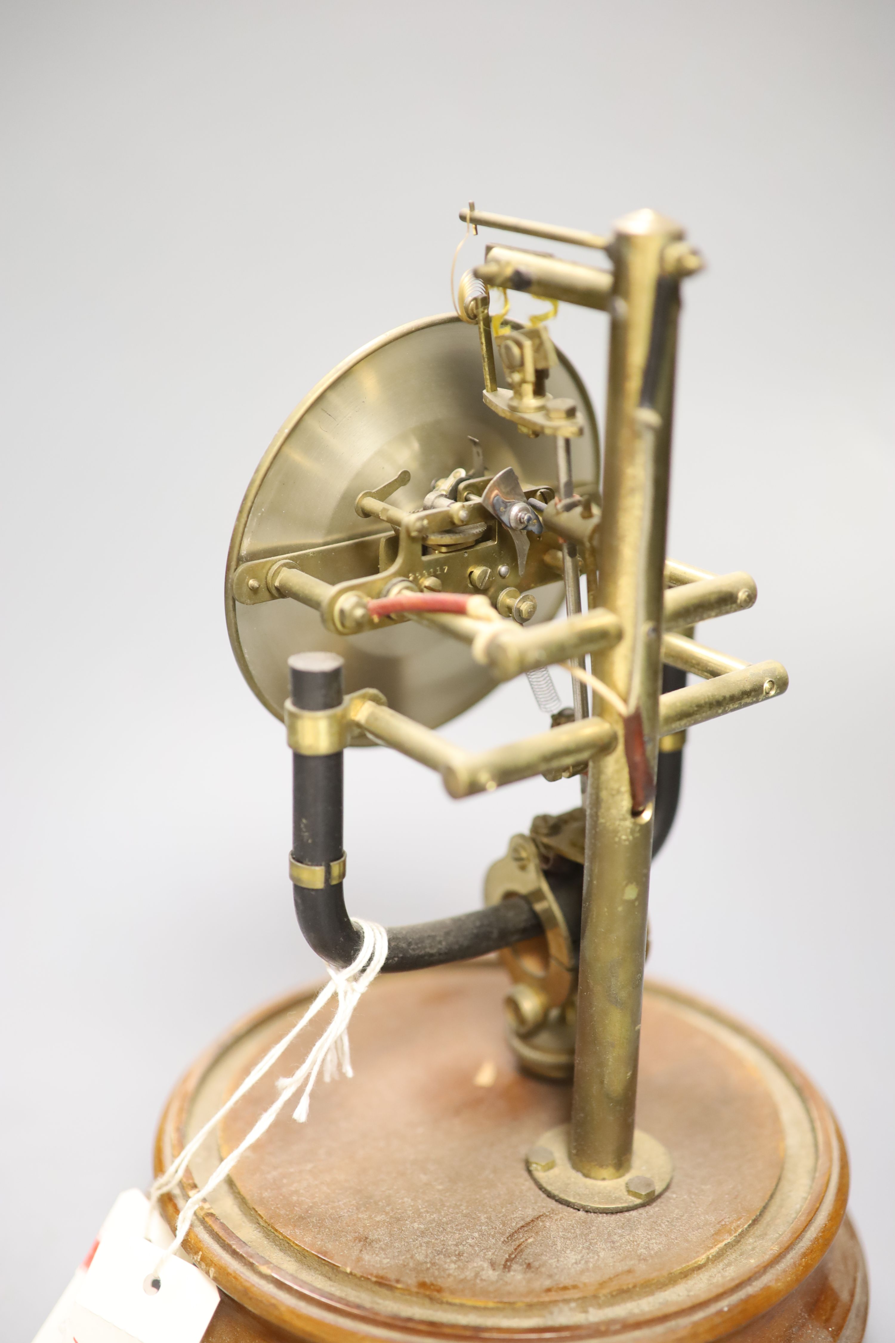 A Bulle type electric mantel clock, under a glass dome, height 26cm